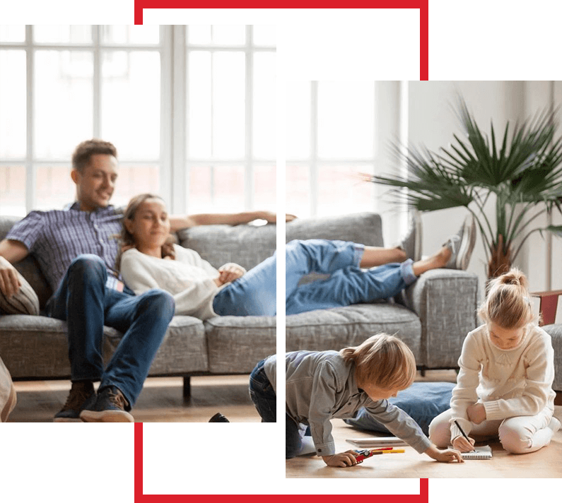 A couple of people sitting on top of a couch.