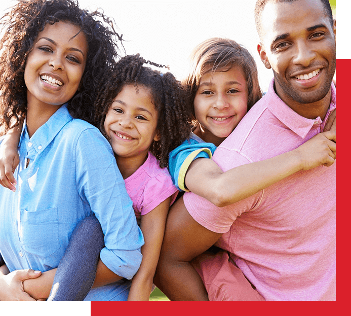 A family of four posing for the camera.