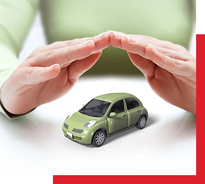 A person holding their hands over a green car.